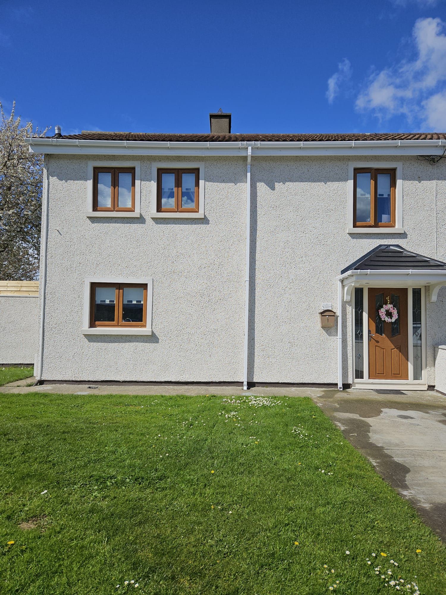 A large white house with a large lawn in front of it.