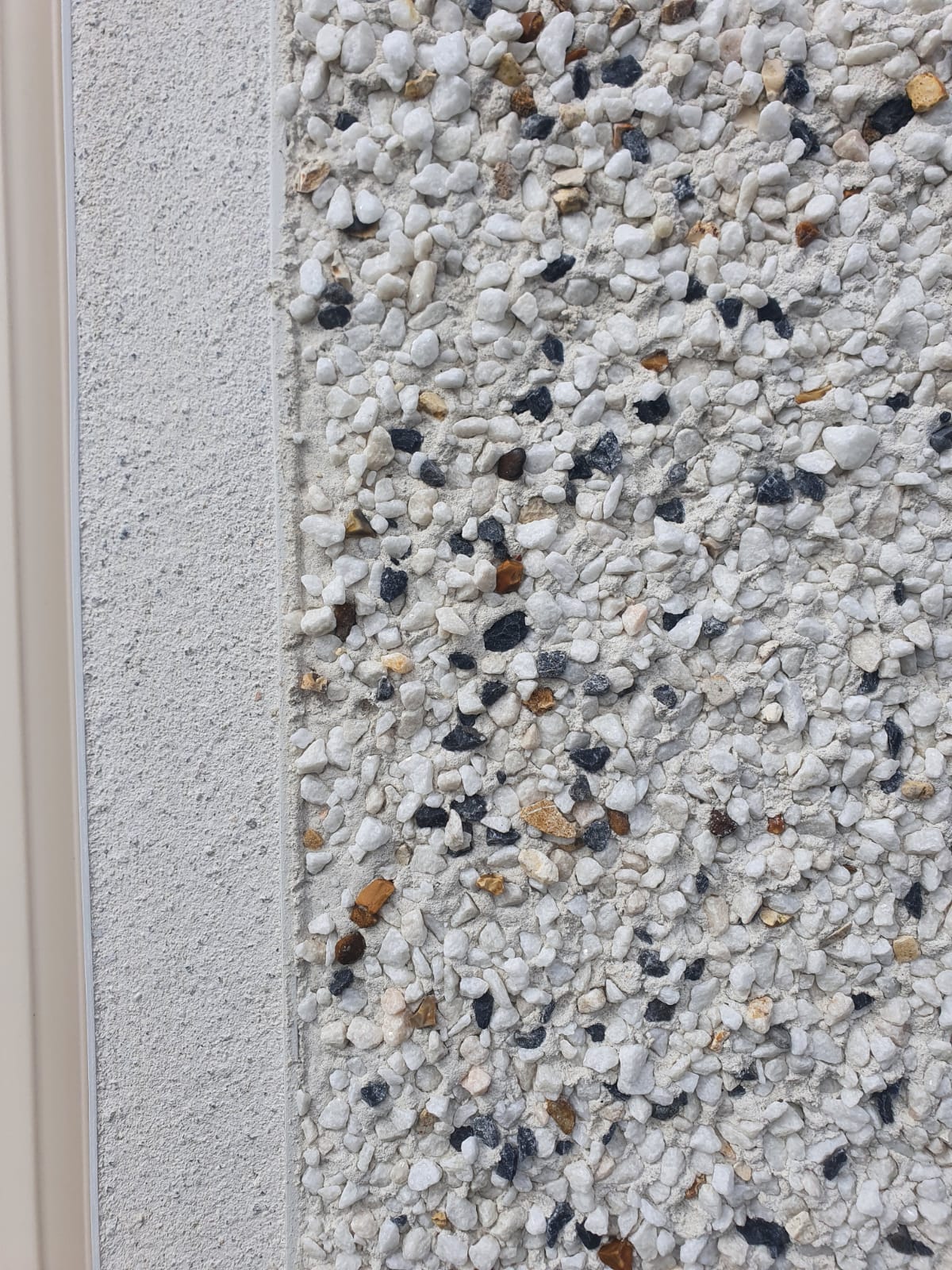 A close up of a wall with a lot of small rocks on it