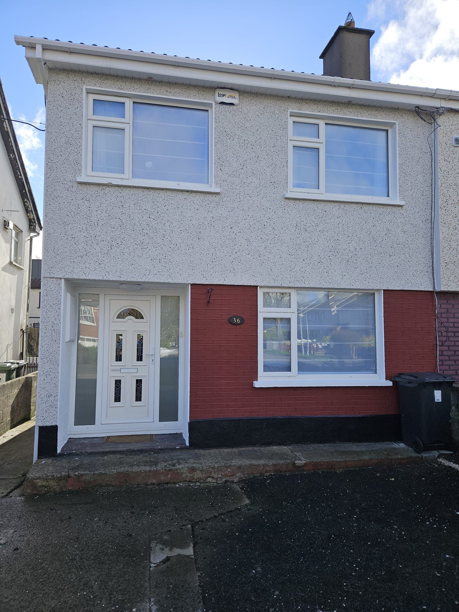 The front of a house with a white door and windows