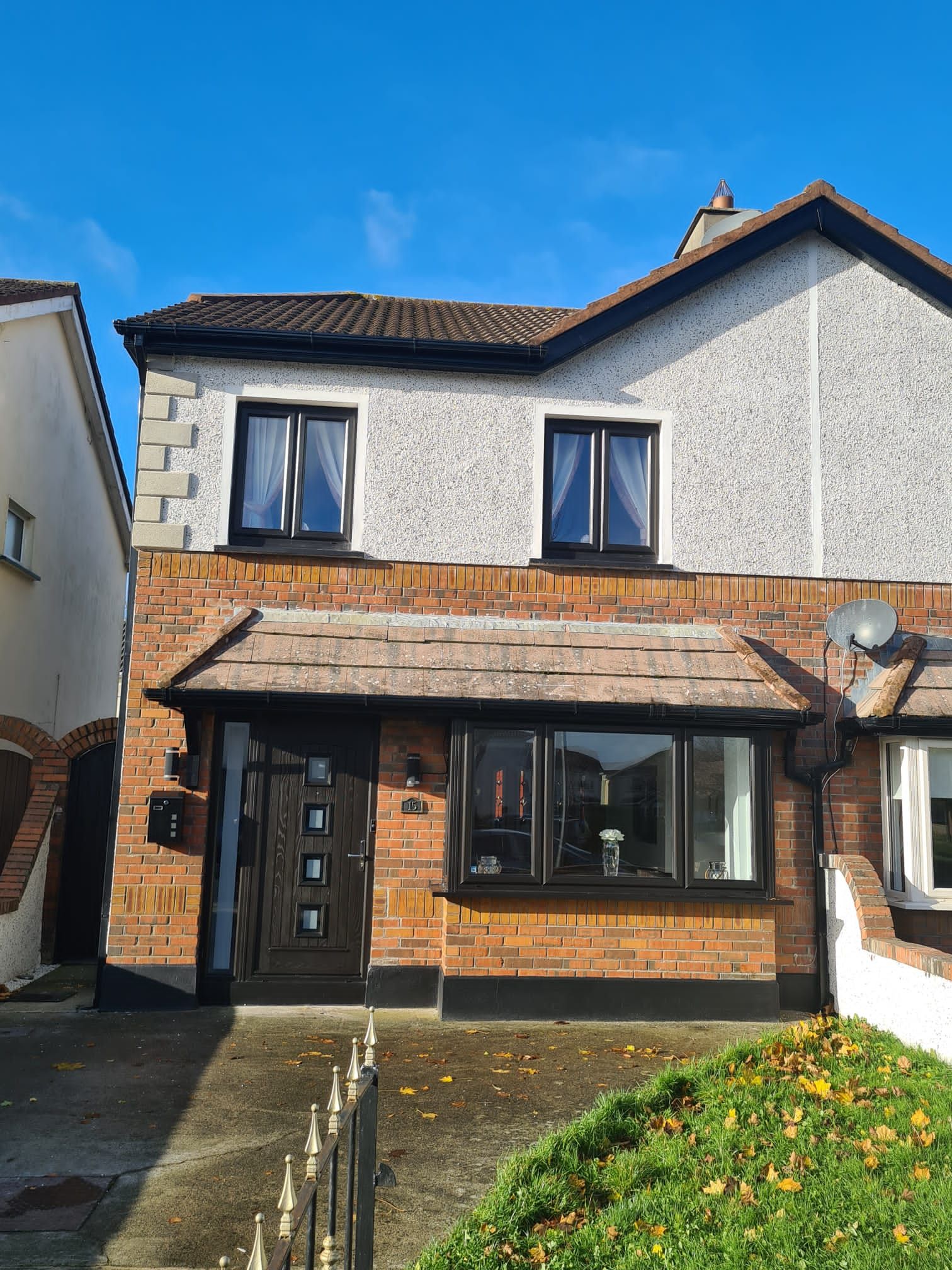A house with a lot of windows and a blue sky in the background
