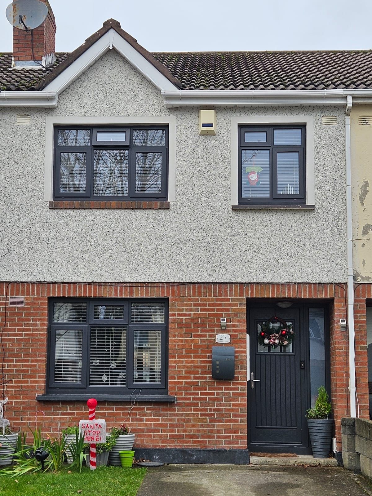 A brick house with black windows and a black door