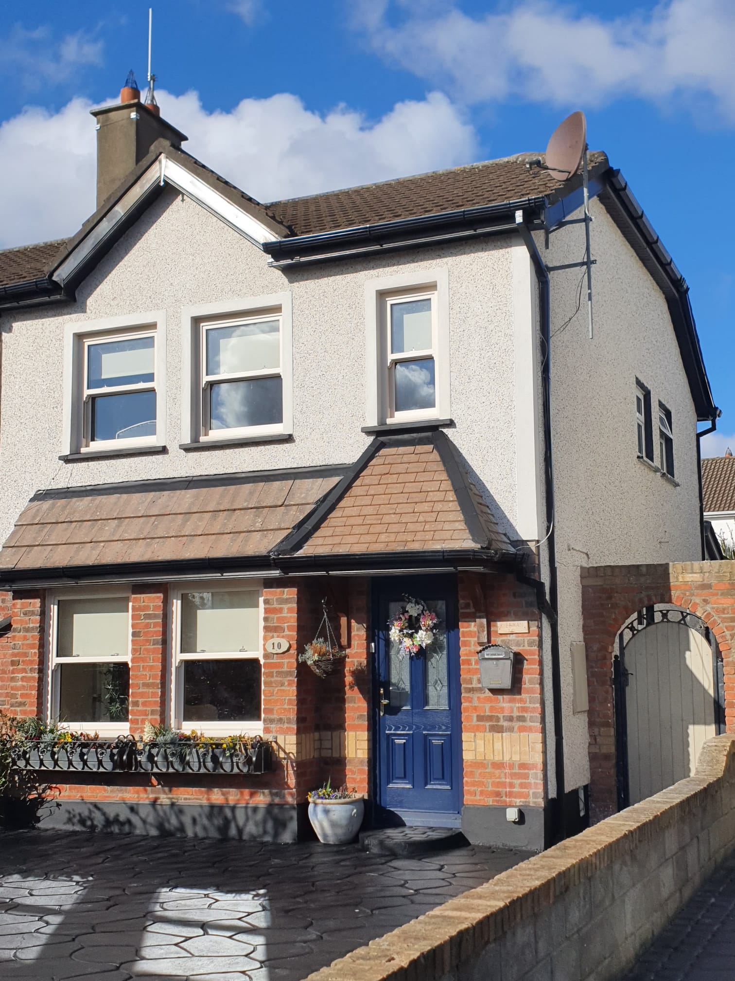 A house with a blue door and a wreath on it