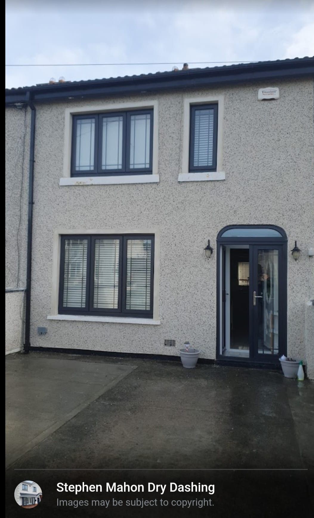 A picture of a house with black windows and a black door.