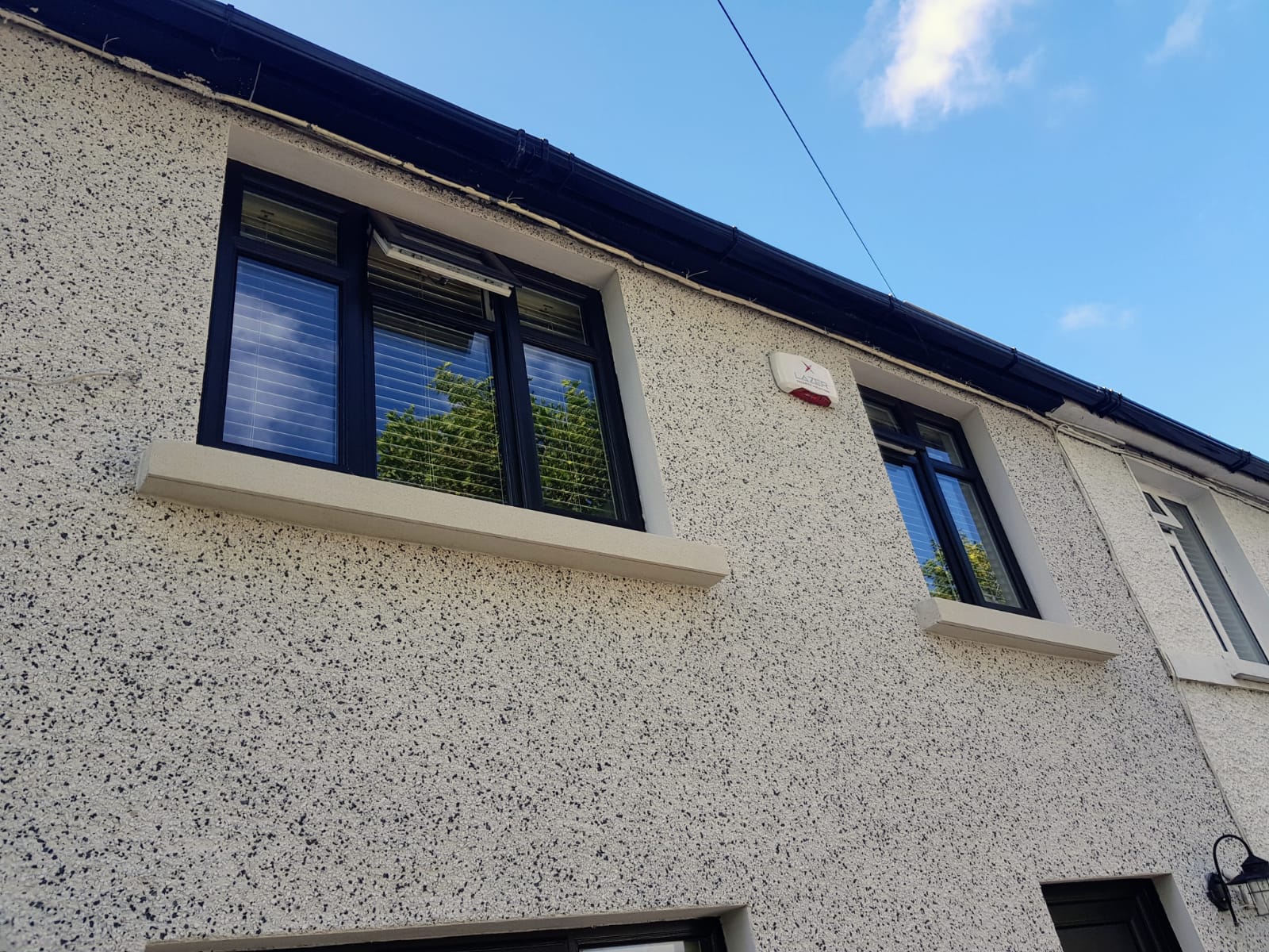 A house with a lot of windows and a roof.