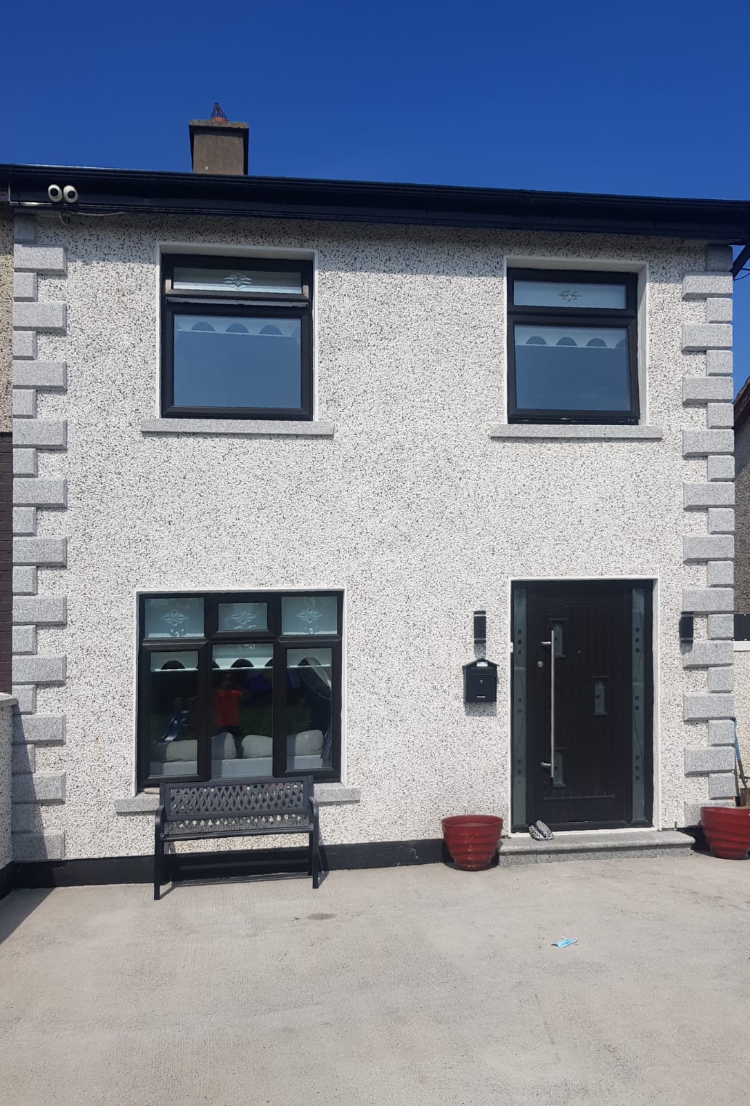 A white house with black windows and a black door
