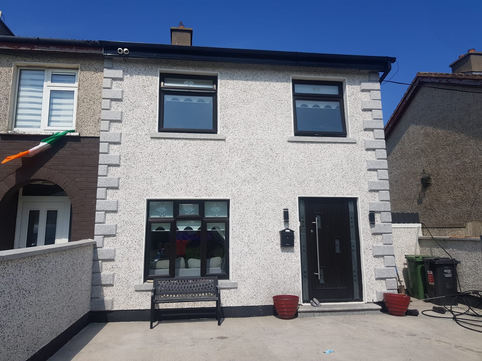 A white house with a bench in front of it