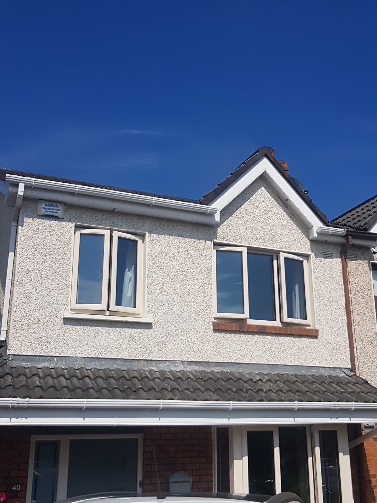 A house with a blue sky in the background