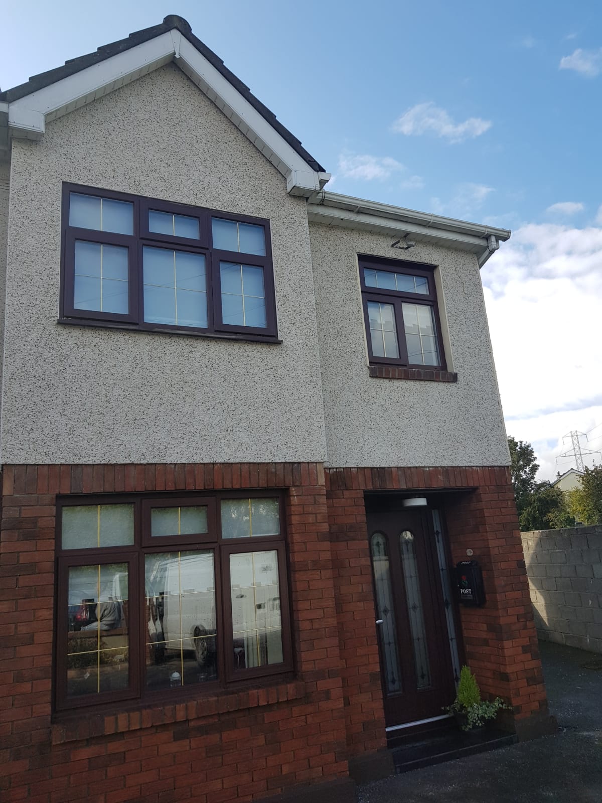 A house with a lot of windows and a blue sky in the background