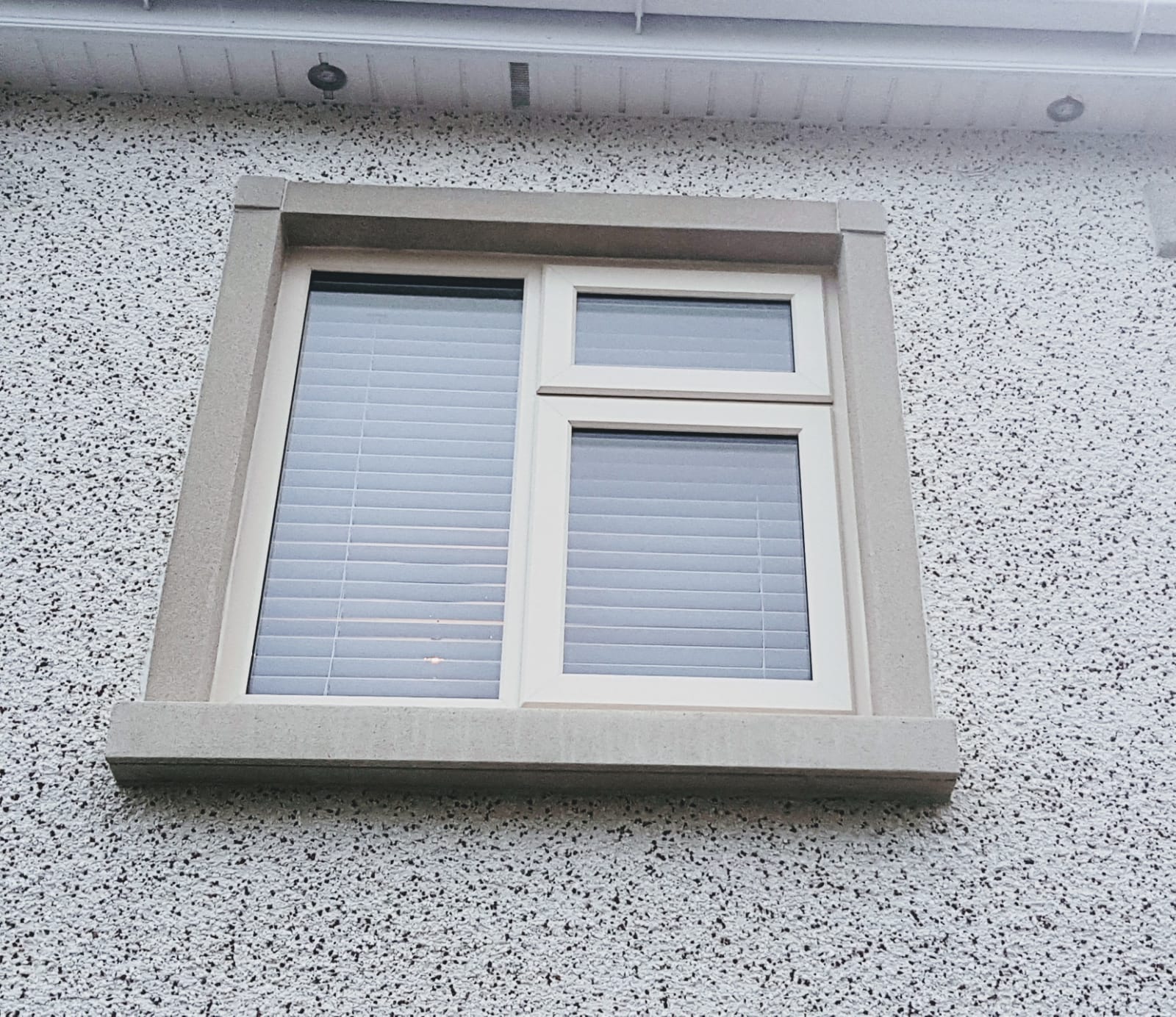 A window on the side of a building with blinds