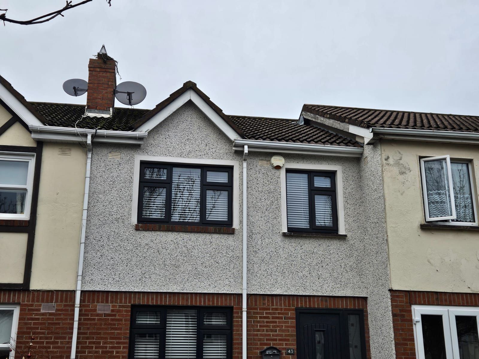 A row of houses with a satellite dish on the roof.