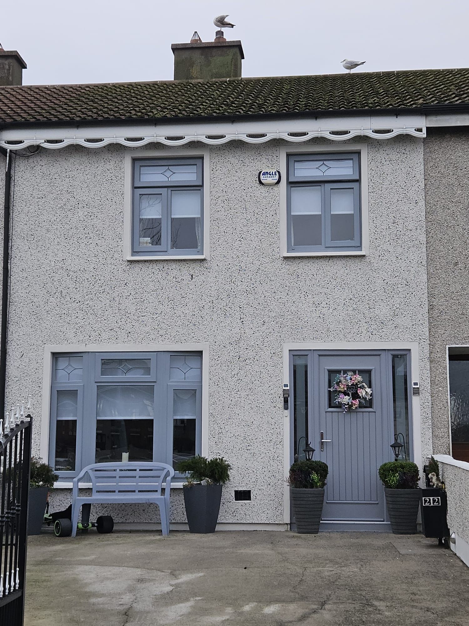 A small house with a blue bench in front of it