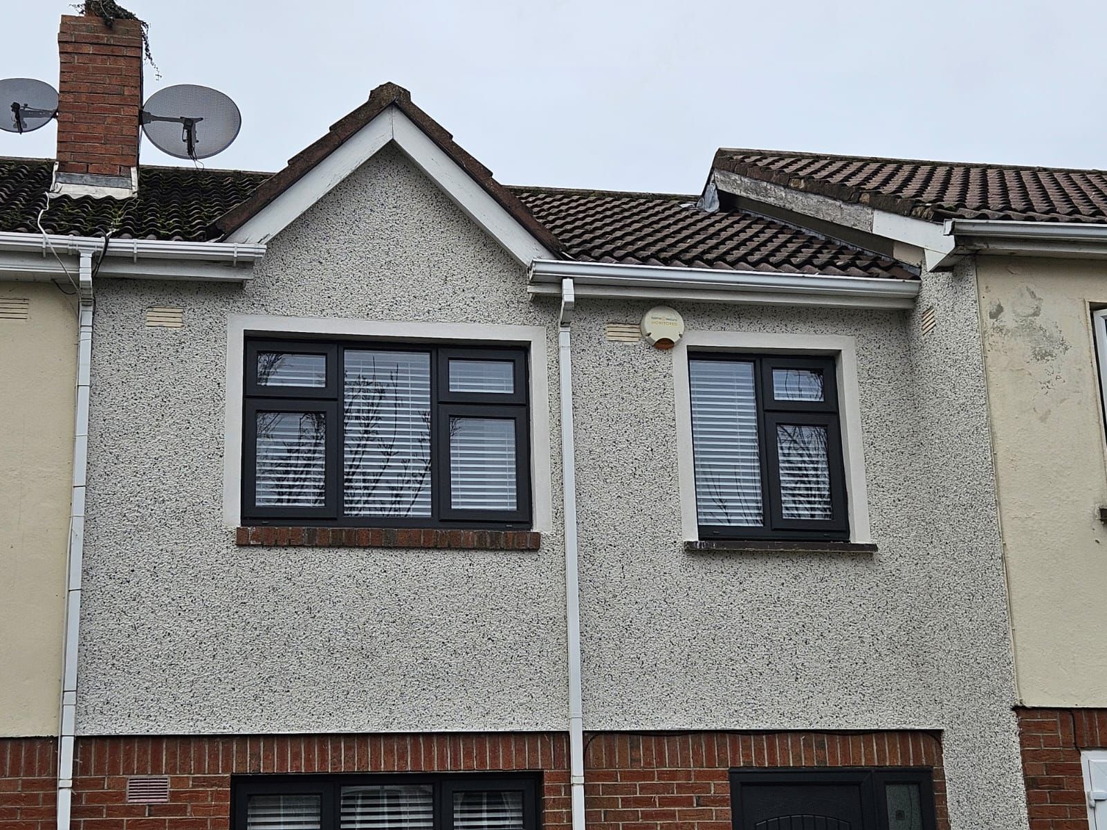 A house with a satellite dish on top of it