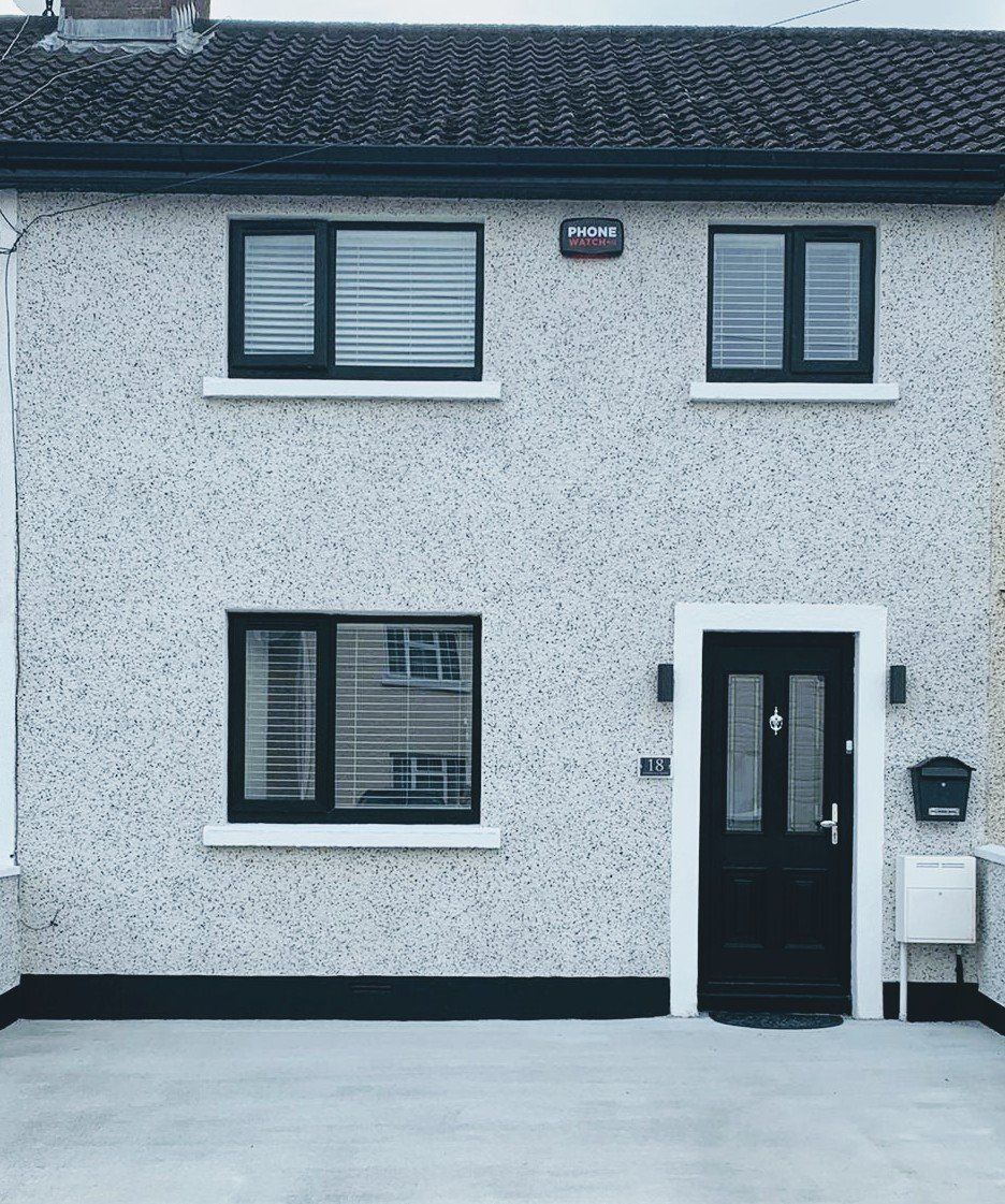 A white house with black windows and a black door
