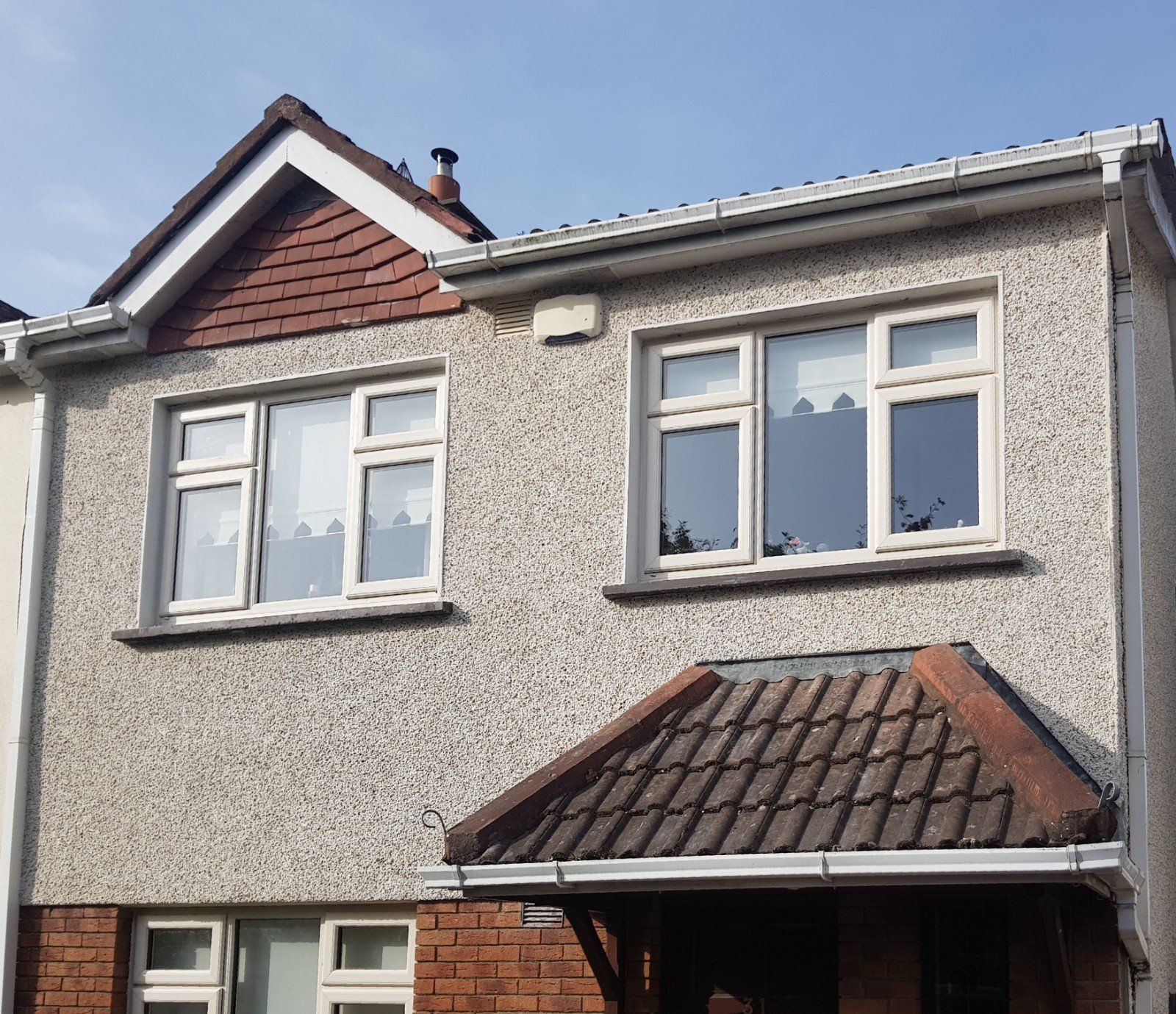 A house with a roof and a few windows