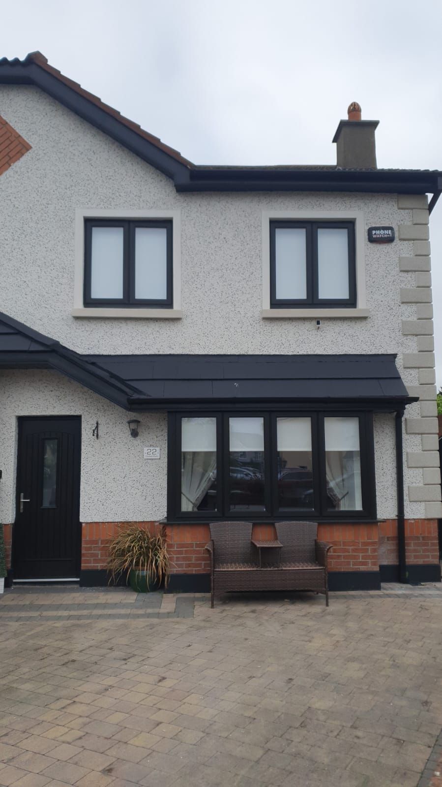 A white house with black windows and a black door