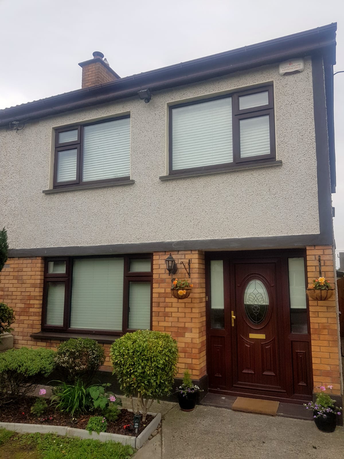 A house with a lot of windows and a brown door