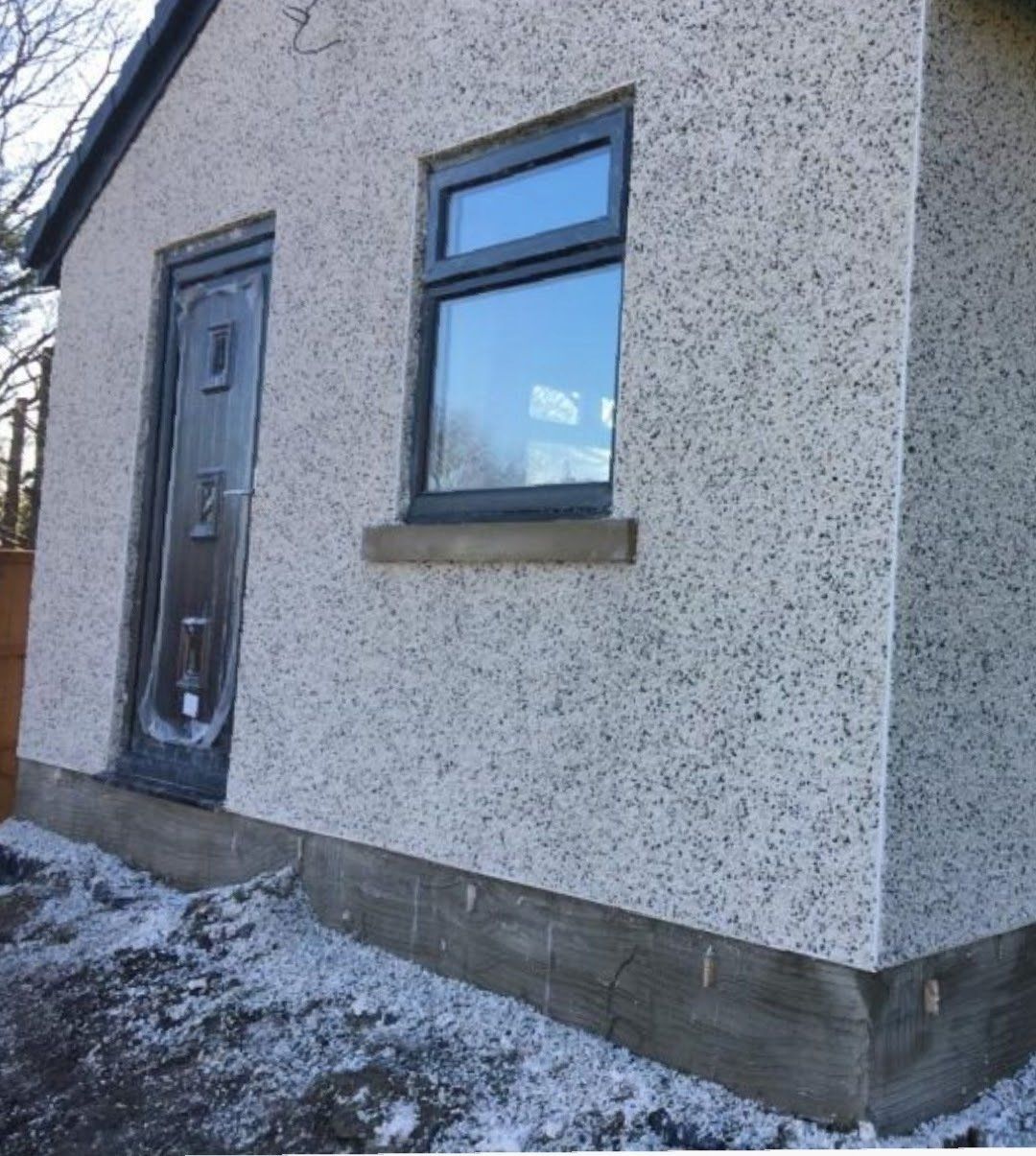 A small house with a black door and a window