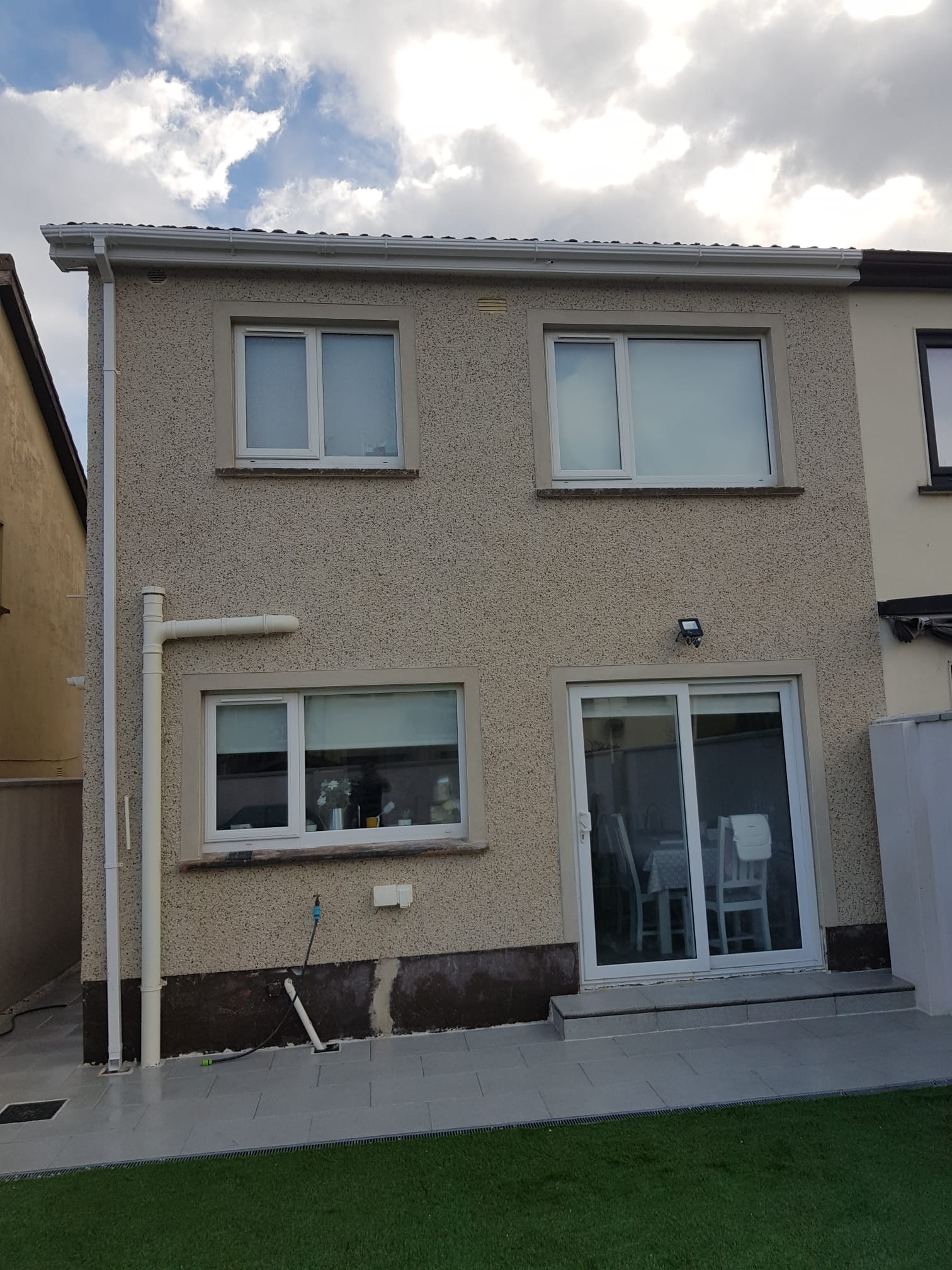 A house with a lot of windows and sliding glass doors