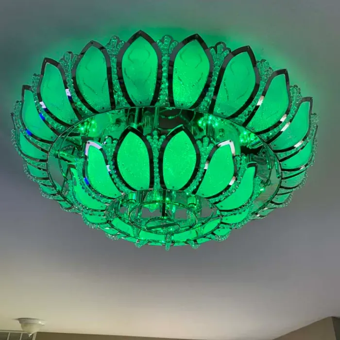A green chandelier is hanging from the ceiling in a room