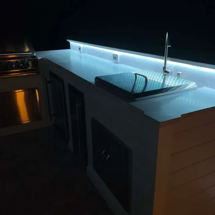 A kitchen with a sink and a stove in it