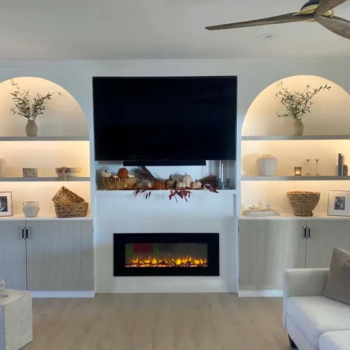 A living room with a fireplace and a flat screen tv.