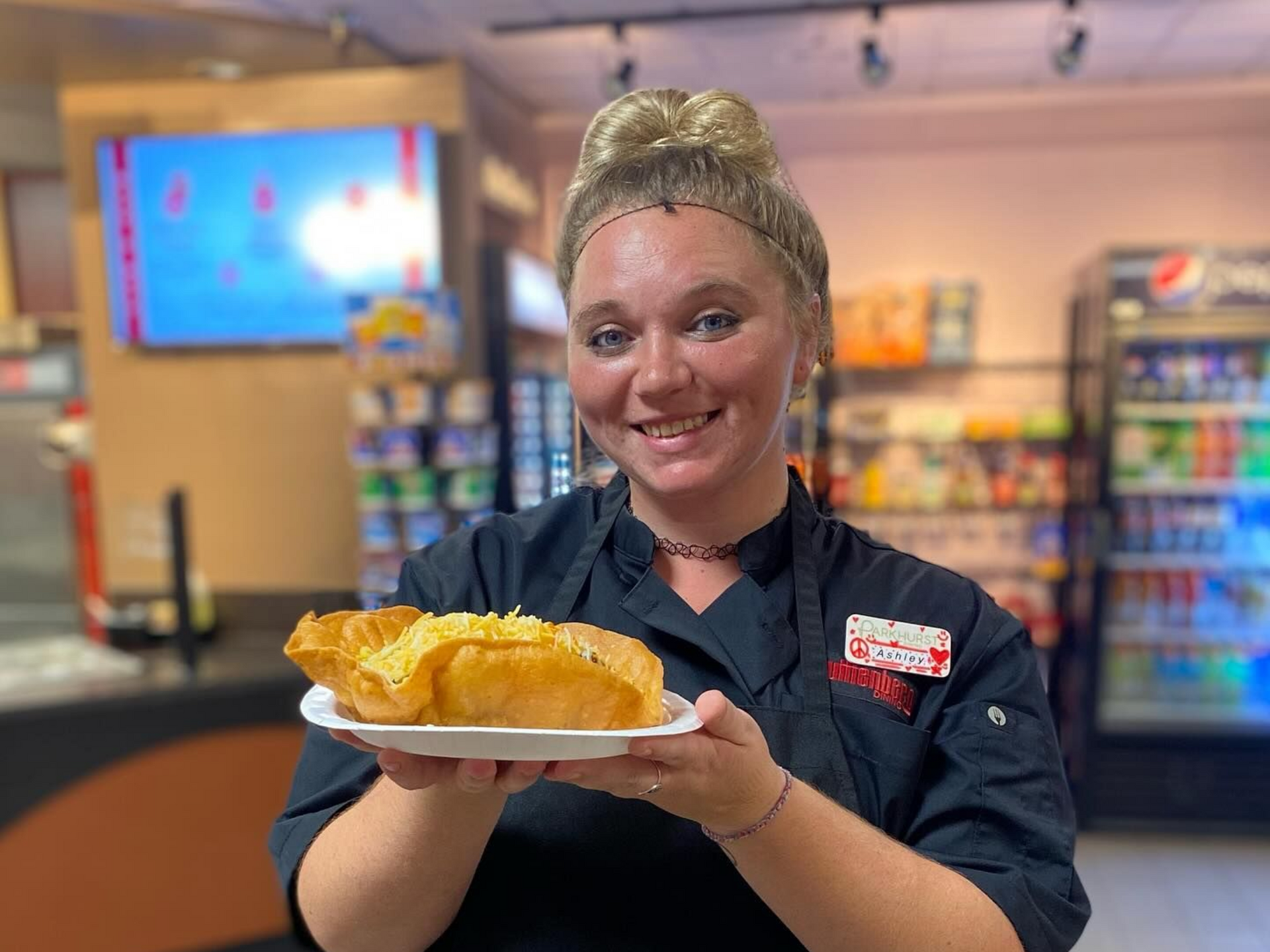A man in a chef 's hat is posing for a picture with two other chefs