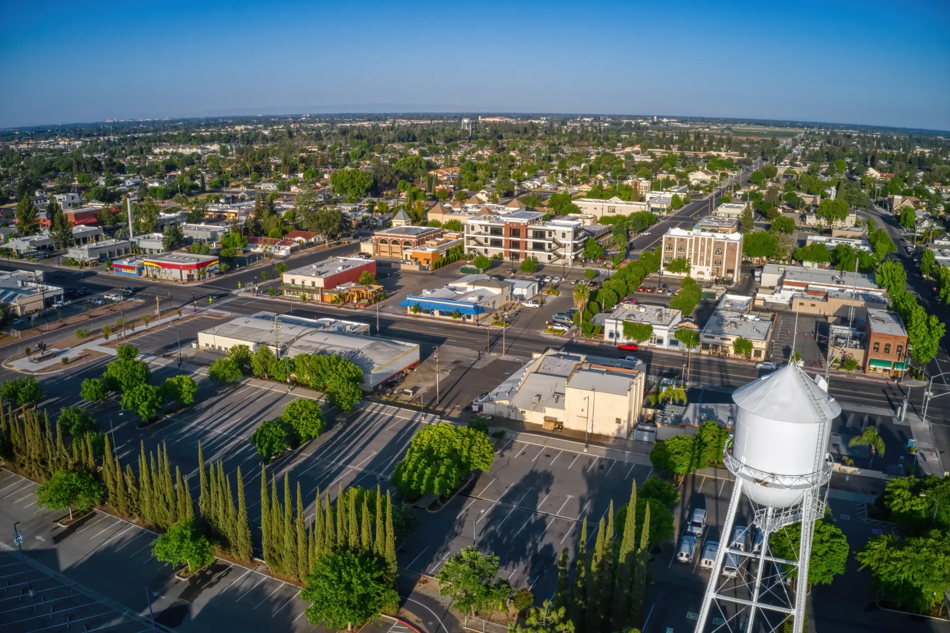An aerial view of a city skyline with a residential area in the foreground.