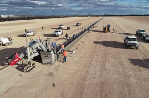 An aerial view of a construction site with trucks and machinery.