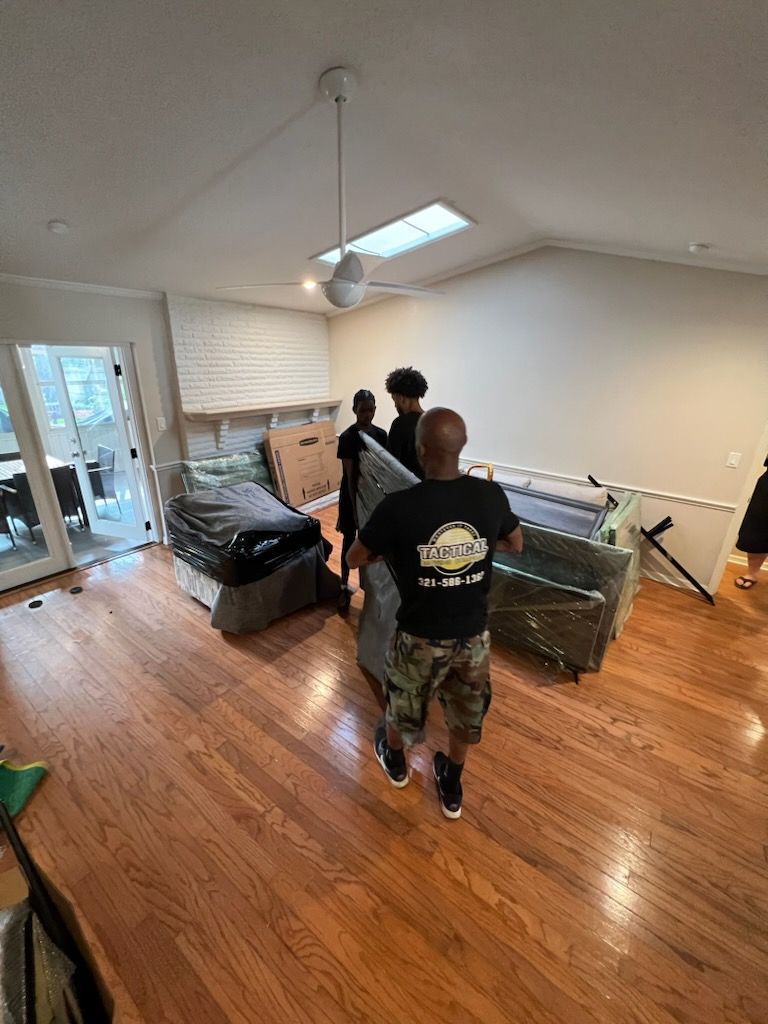 Workers Placing Down The White Sofa