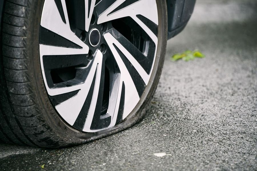 A close up of a flat tire on a car.