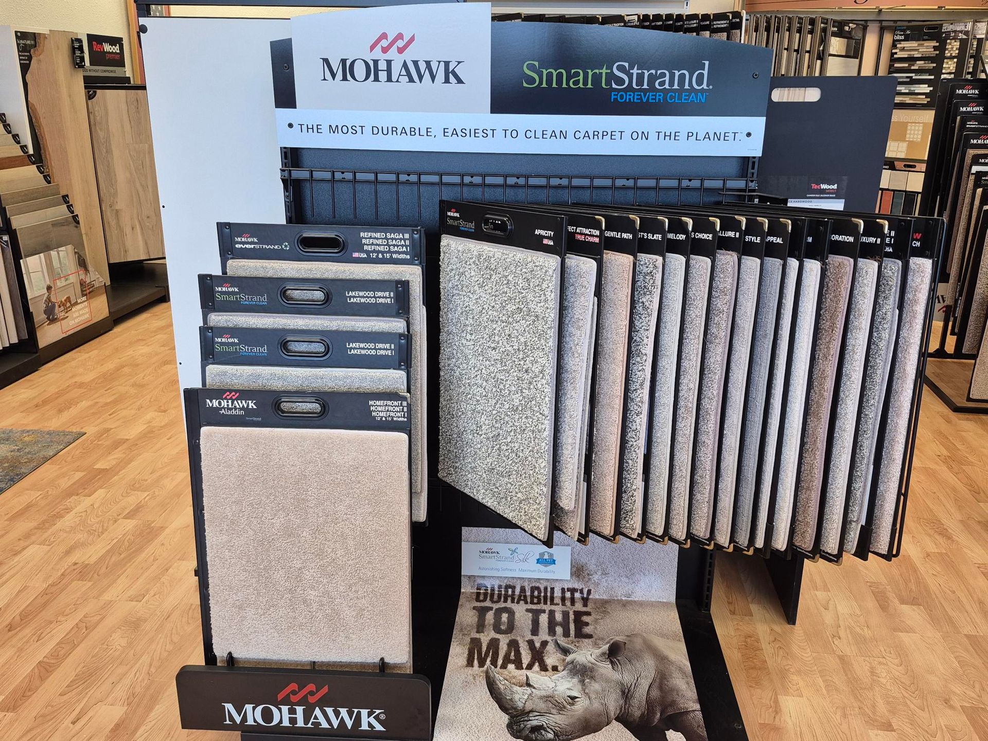 A display of carpets and tiles on shelves in a store.