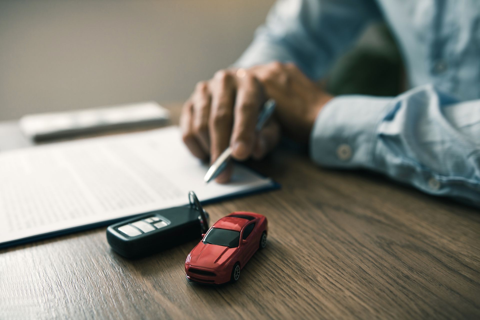An older couple reviews documents with a financial advisor at a table.