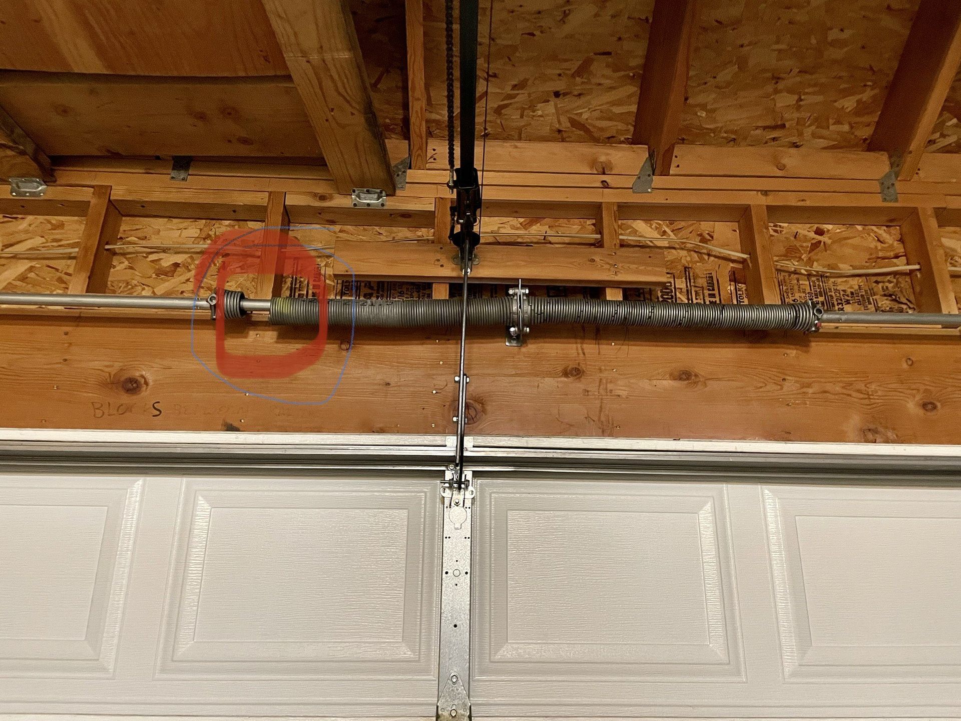 A car is parked in a garage with the door open.