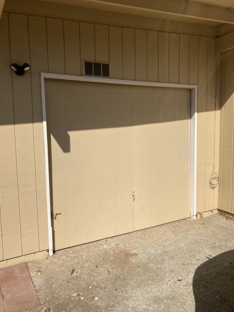 A garage door with a light on the side of it.
