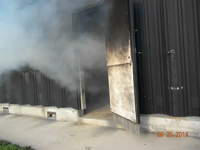 Smoke is coming out of the door of a training building.