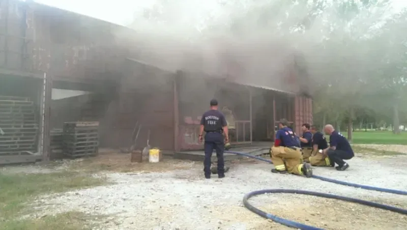 A group of firefighters are fighting a house fire.