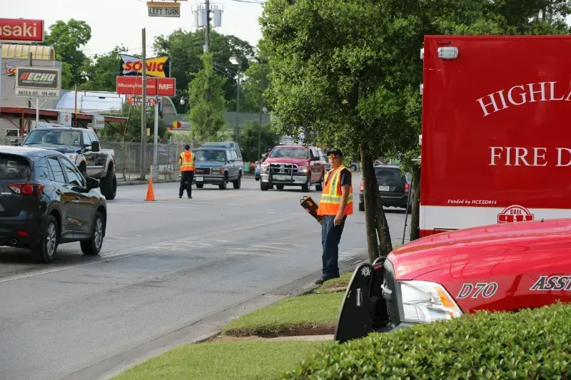 A red highland fire truck is parked on the side of the road