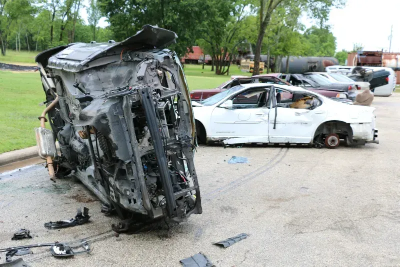 A car that has been turned upside down in a parking lot.