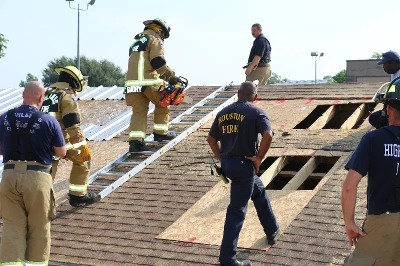A group of firefighters are training on venting a roof