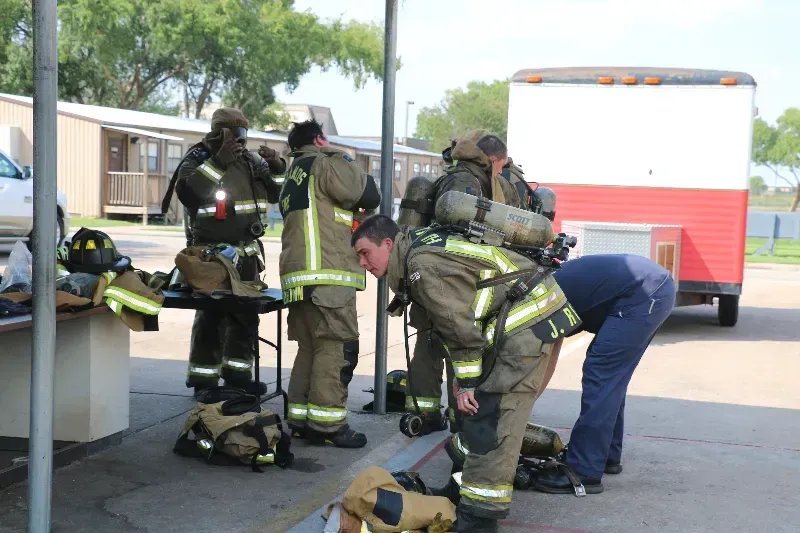 A group of firefighters are getting ready for a fire