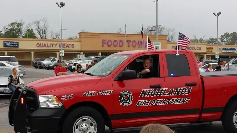 A red Highlands fire department truck is driving in a parade line.