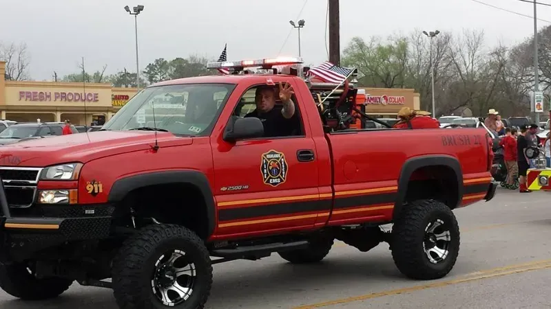 A Highlands Fire Department vehicle with the number 911 on it is driving in a parade