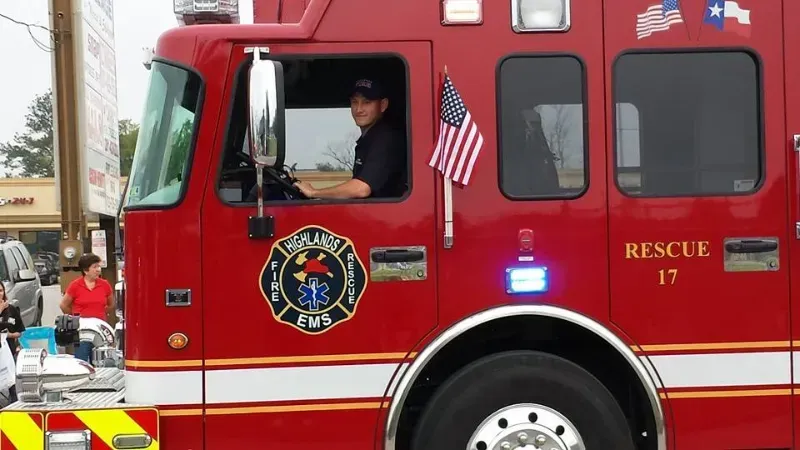 A Highlands fire truck with the number 17 on it is driving in a parade.
