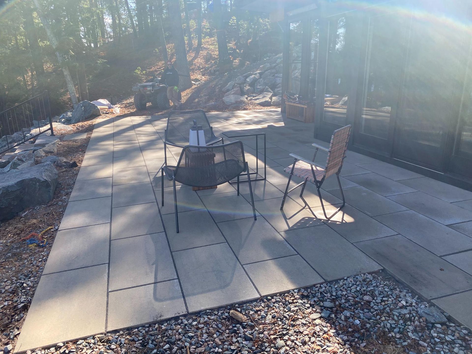 A patio with a table and chairs and a fire pit.