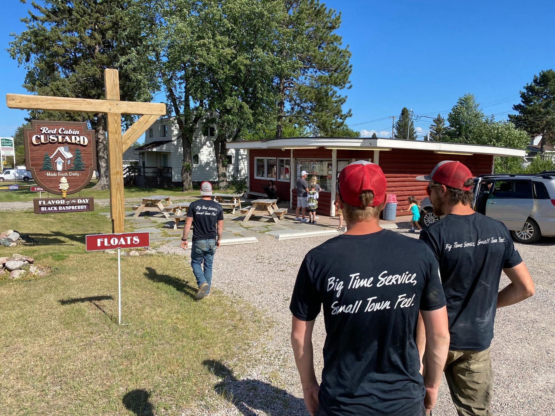 A group of men are standing in front of a restaurant.