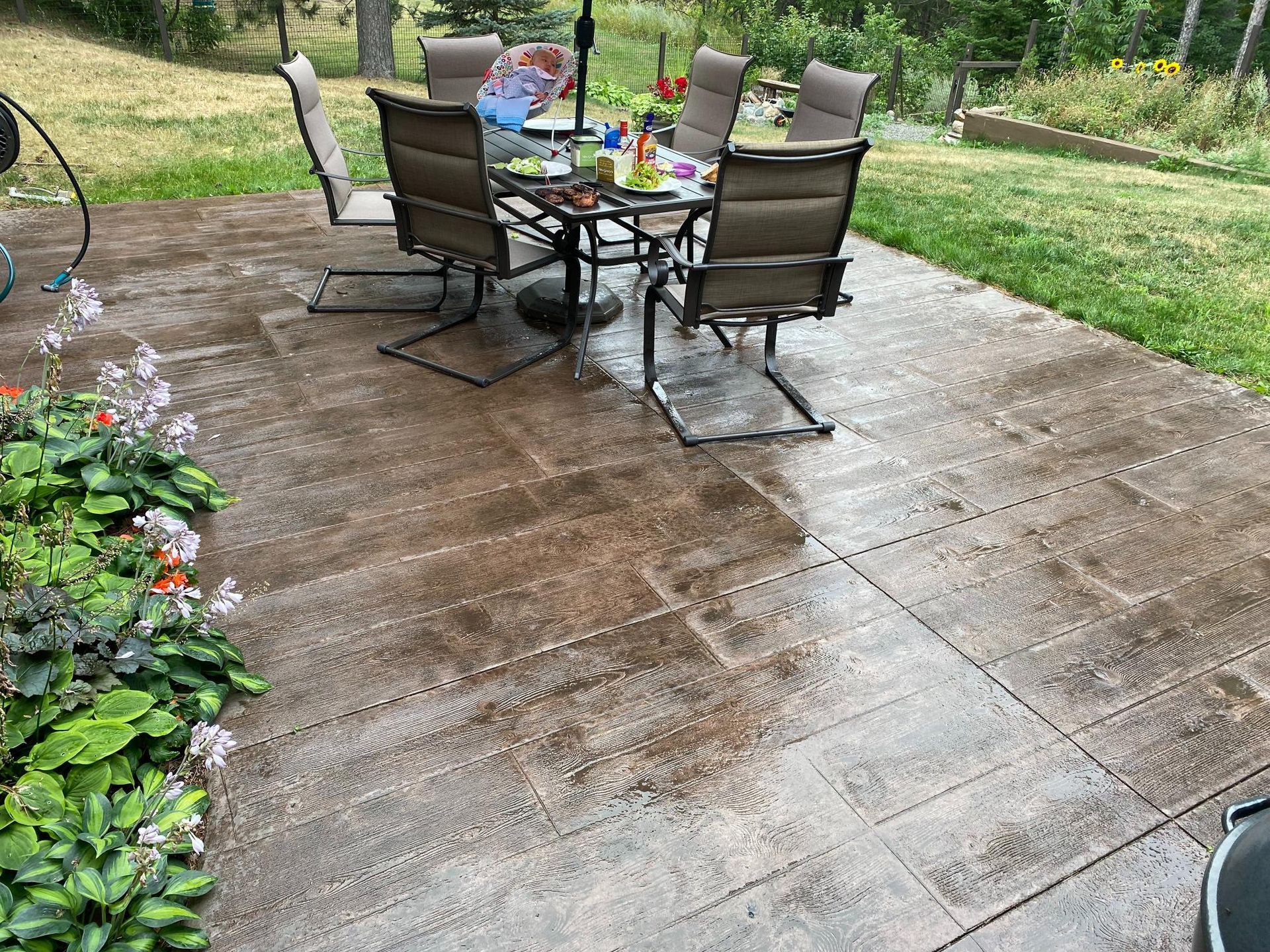 A patio with a table and chairs on it.