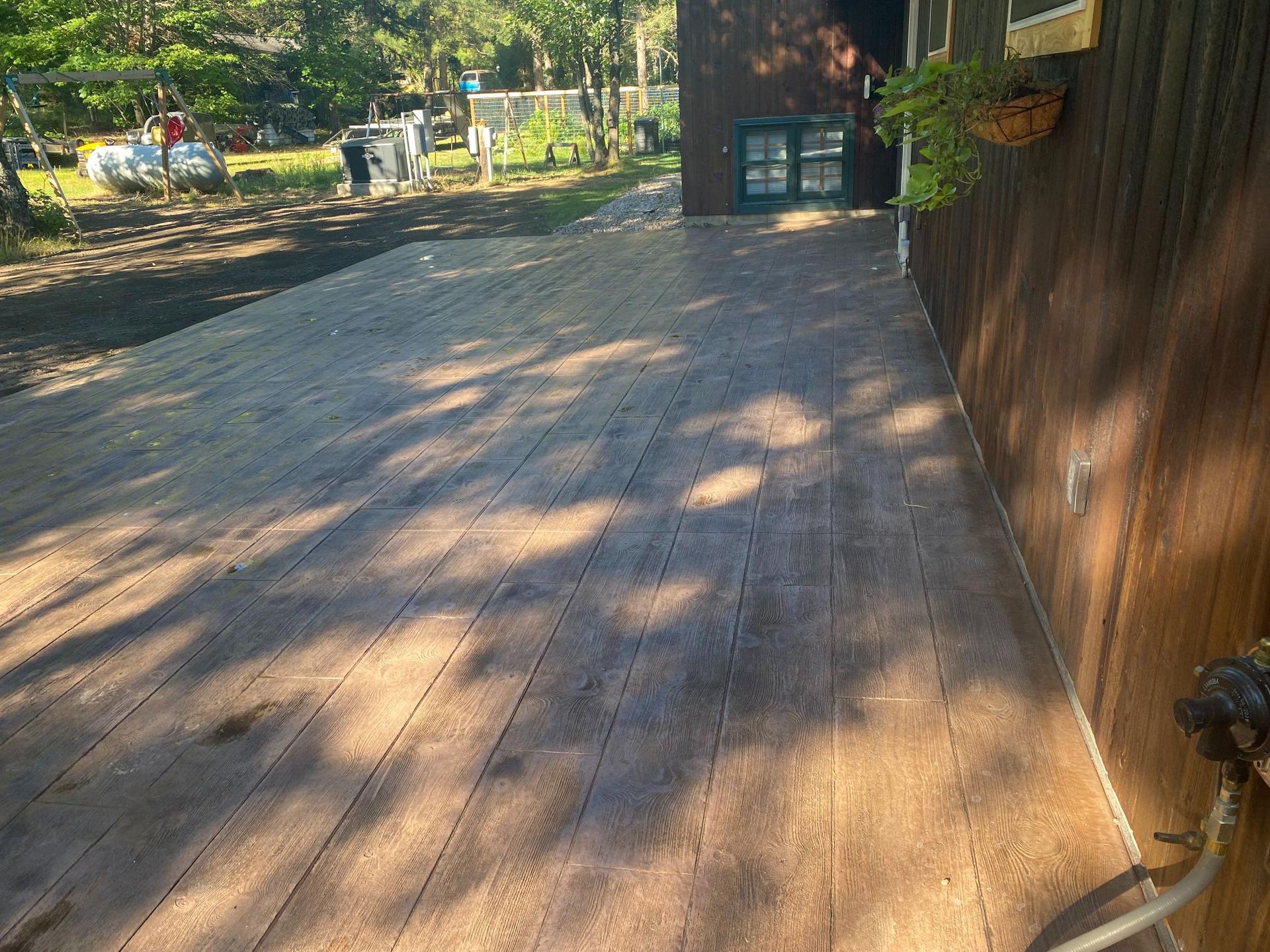A wooden deck is being built in front of a house.