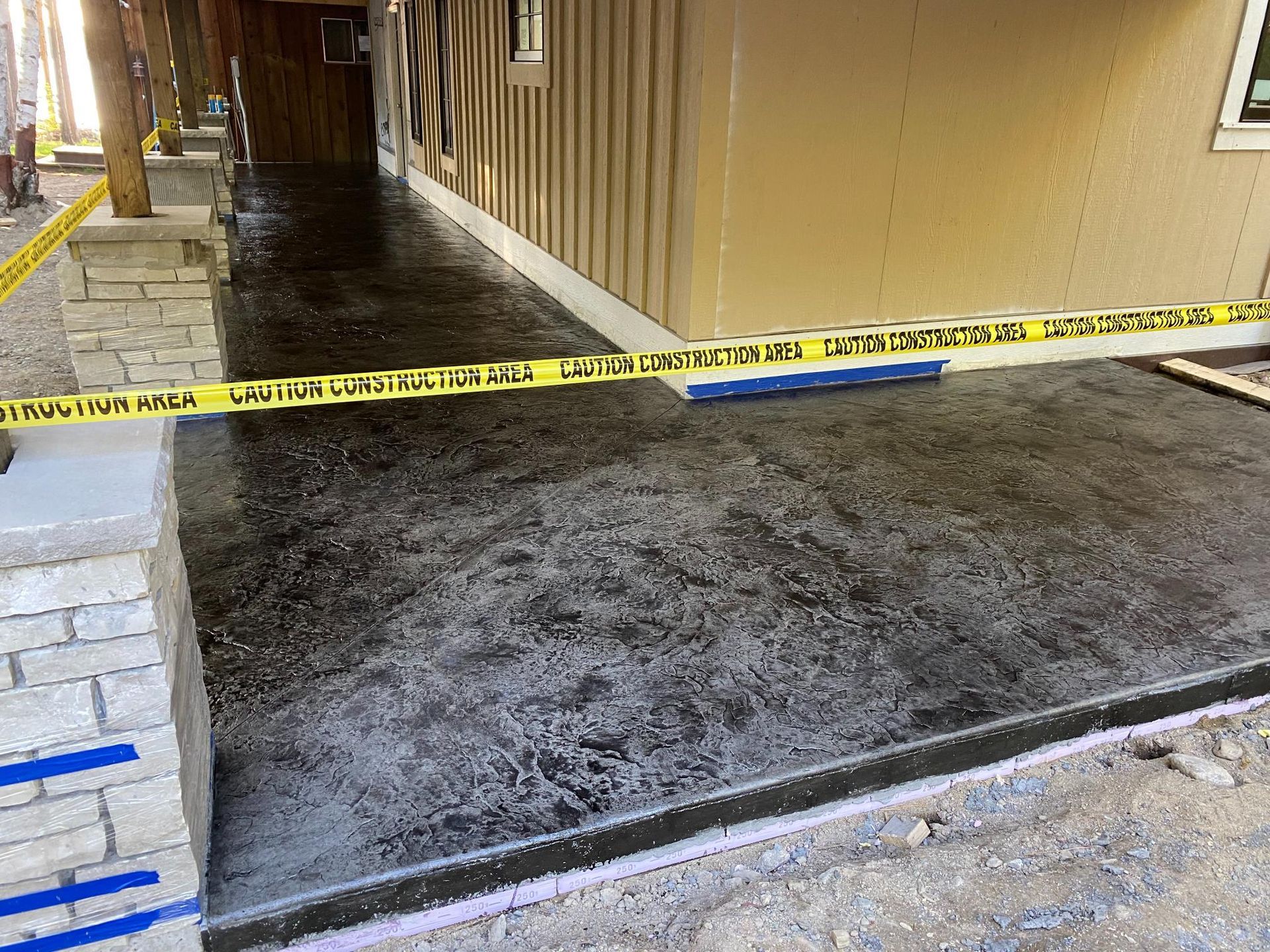 A concrete walkway is being built in front of a building.