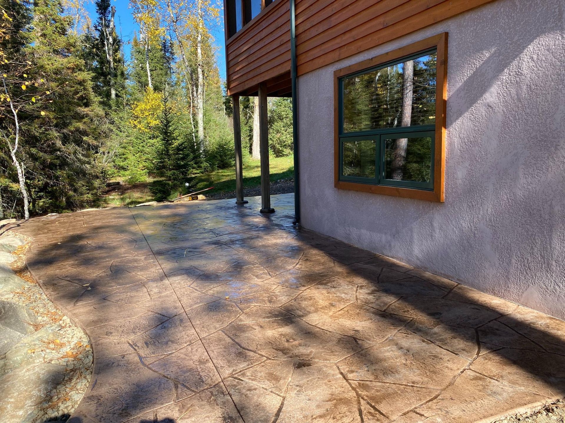 A house with a patio and a window on the side of it.