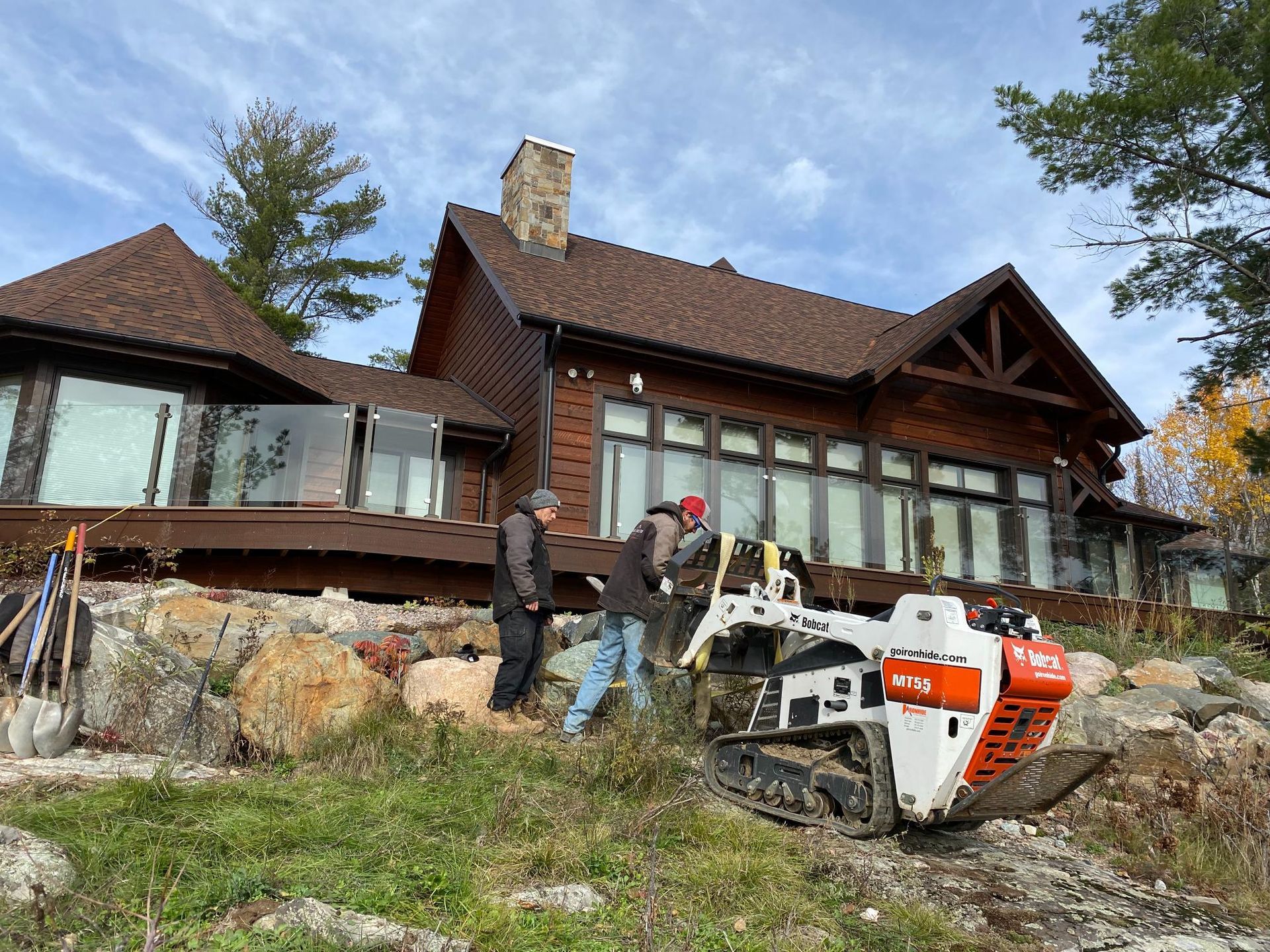 A group of men are standing in front of a large house.